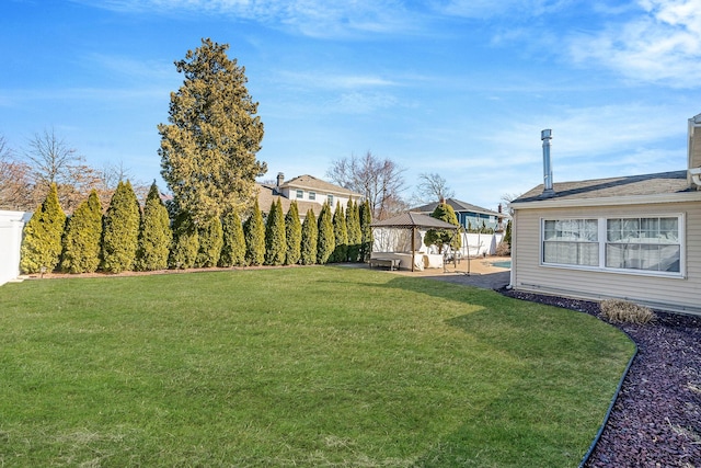 view of yard with fence and a gazebo