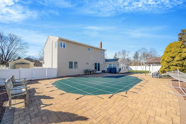 view of pool featuring a fenced backyard and a patio