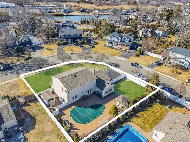 drone / aerial view with a residential view and a water view