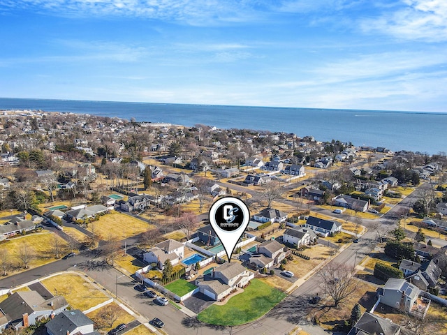 drone / aerial view with a water view and a residential view