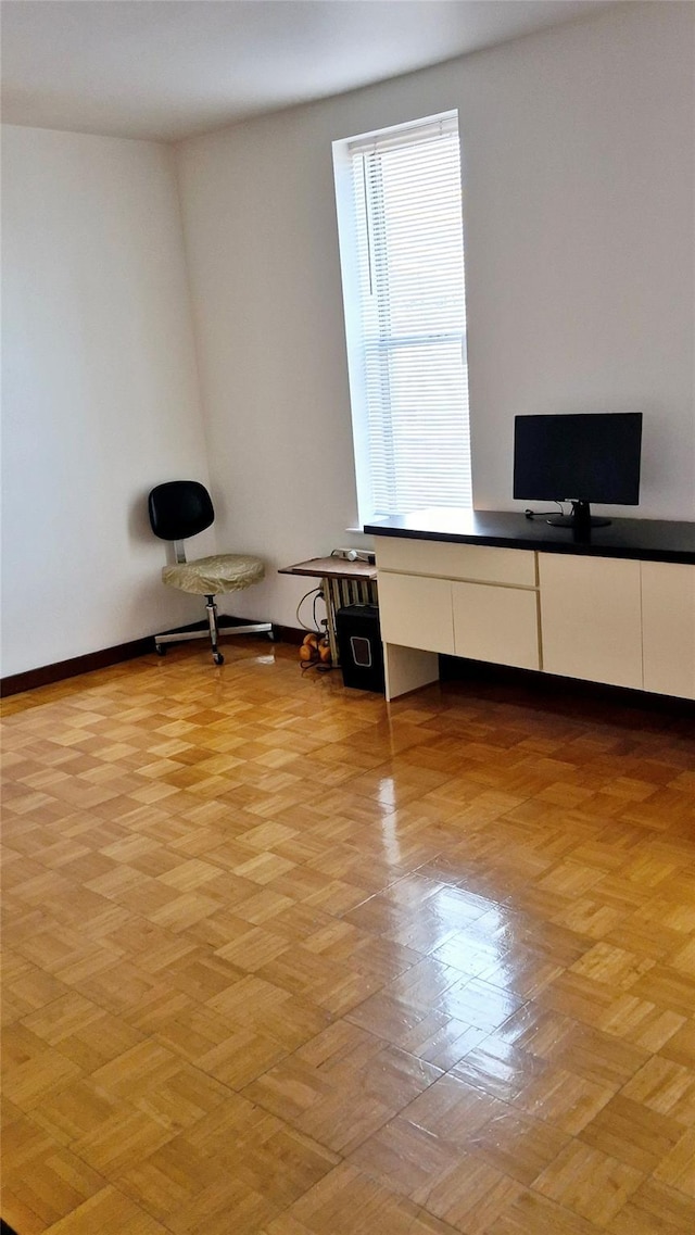 unfurnished office featuring baseboards