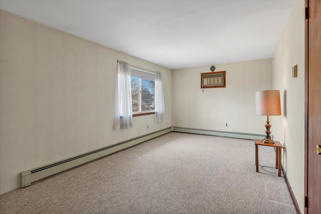 carpeted spare room with a baseboard radiator