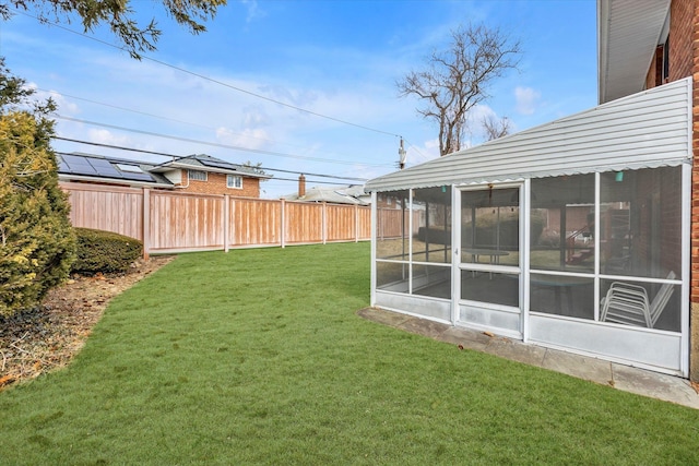 view of yard featuring a sunroom and fence