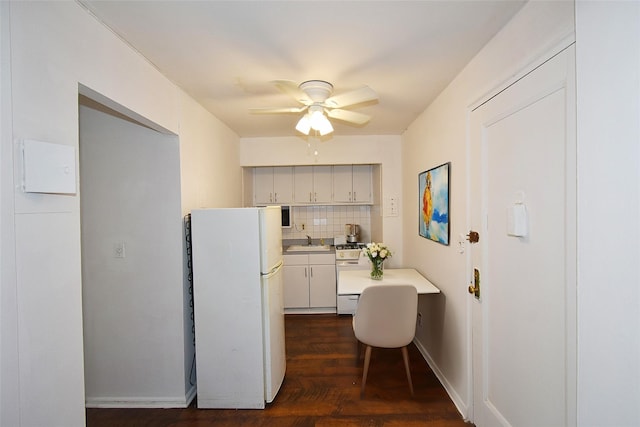 kitchen with white appliances, ceiling fan, a sink, light countertops, and backsplash