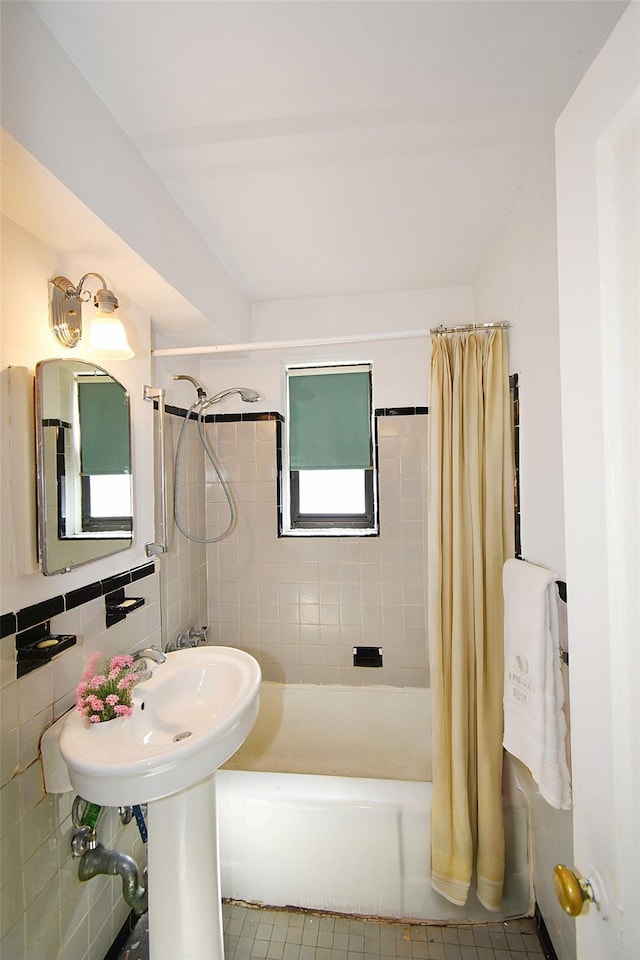 full bath featuring tile patterned flooring, tile walls, and shower / tub combo with curtain