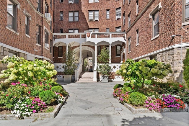 view of exterior entry featuring brick siding