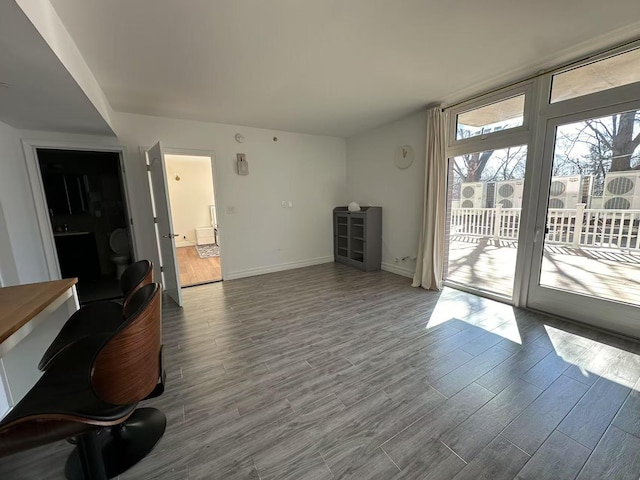 interior space featuring baseboards and wood finished floors