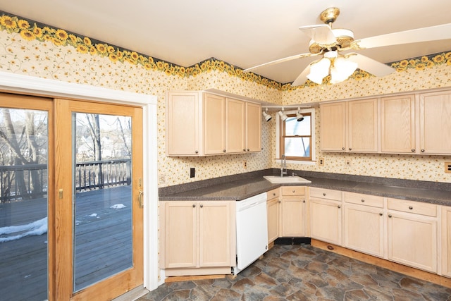 kitchen with dishwasher, a sink, and wallpapered walls