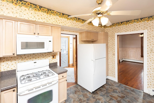 kitchen featuring a baseboard radiator, dark countertops, stone finish flooring, white appliances, and wallpapered walls