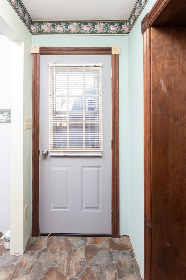 doorway featuring stone finish floor