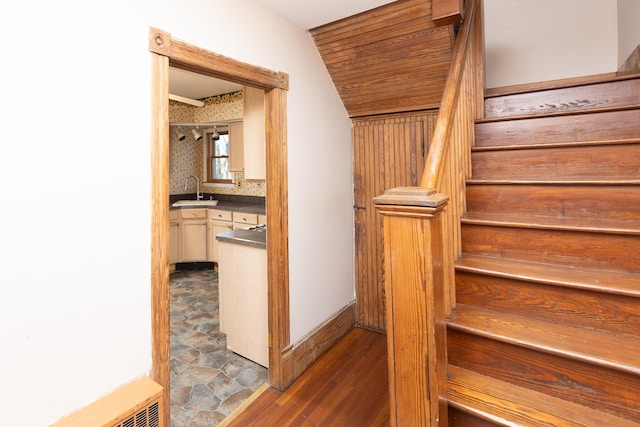 stairway with wood ceiling, baseboards, and wood finished floors