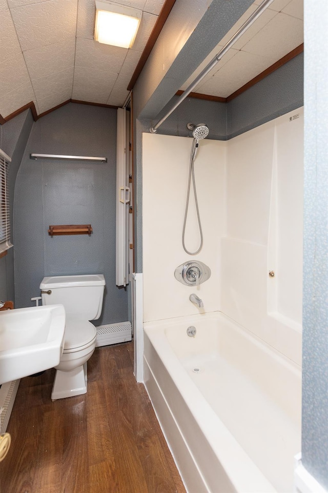 full bath featuring toilet, a sink, tub / shower combination, and wood finished floors