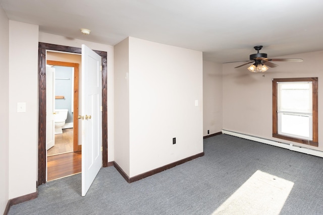 carpeted spare room featuring a baseboard heating unit, baseboards, and a ceiling fan