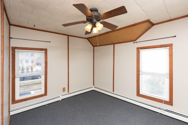 carpeted spare room with a ceiling fan, vaulted ceiling, and crown molding