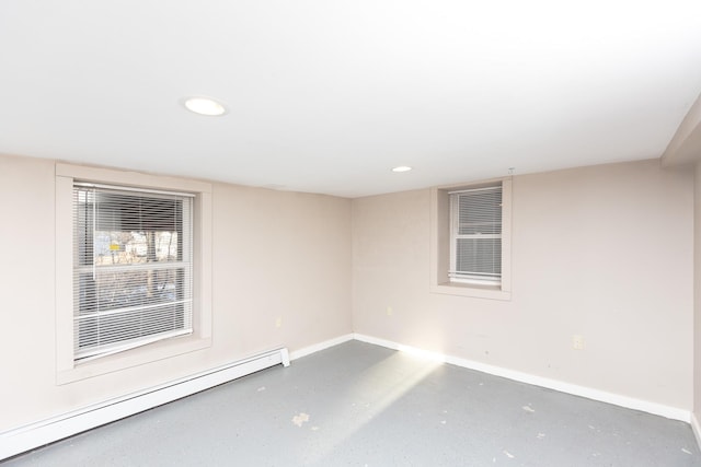 empty room featuring recessed lighting, baseboards, finished concrete flooring, and baseboard heating