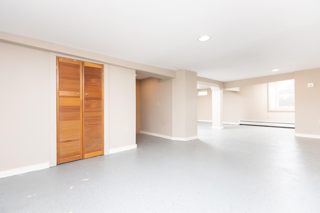 finished basement with baseboards, baseboard heating, and recessed lighting