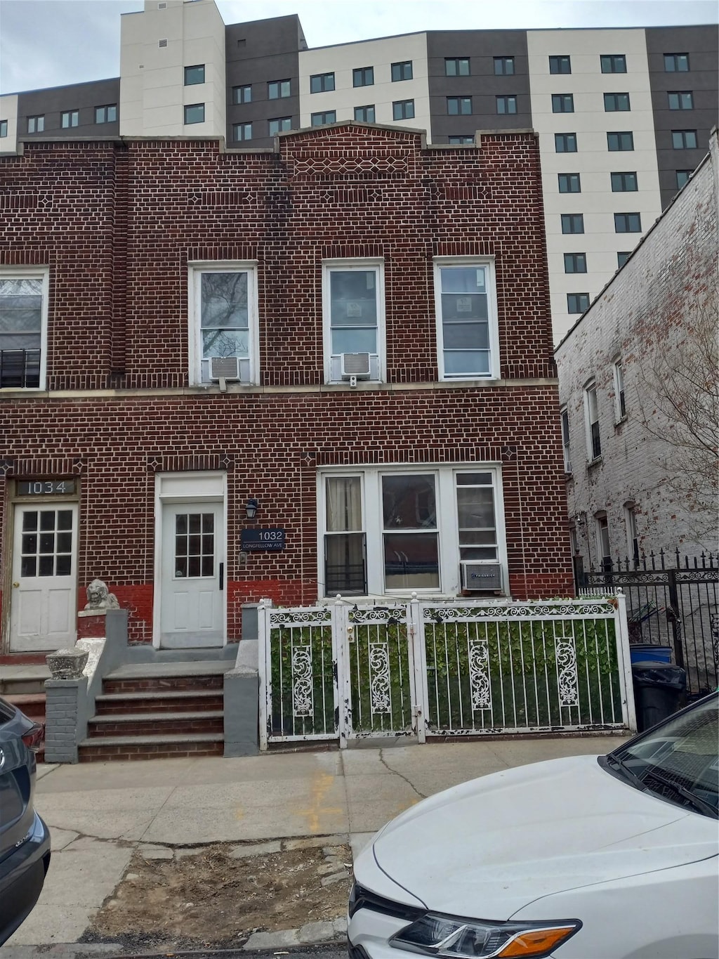 view of building exterior with a fenced front yard and cooling unit