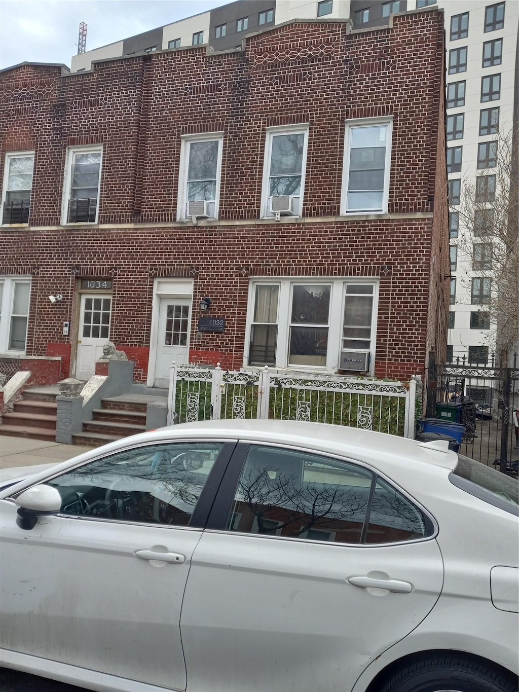 view of property with a fenced front yard and brick siding