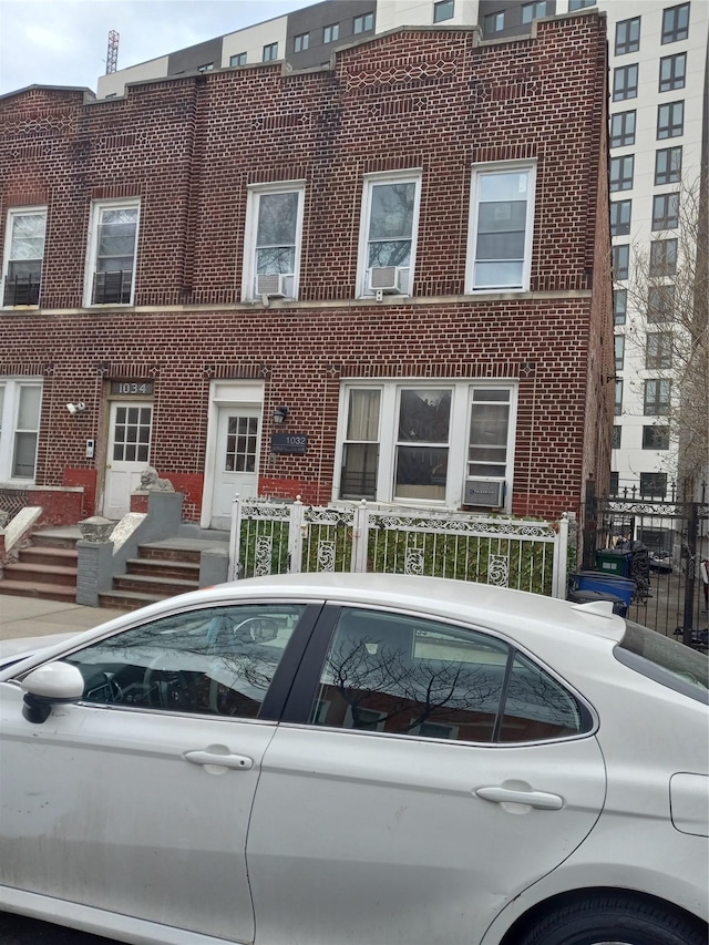 view of property with a fenced front yard and brick siding