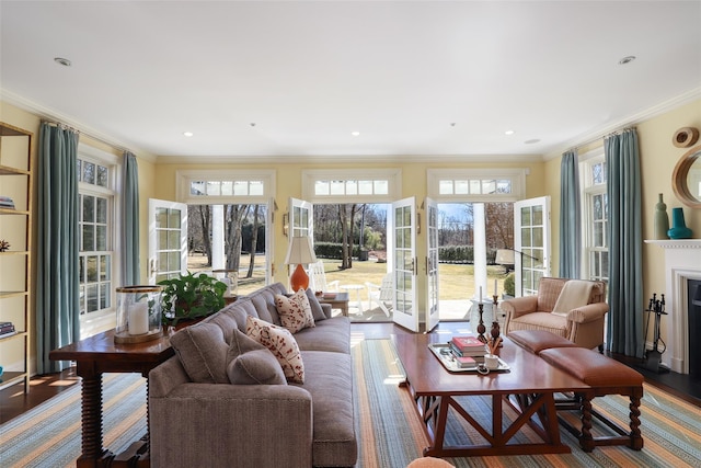 living area with french doors, ornamental molding, wood finished floors, and recessed lighting