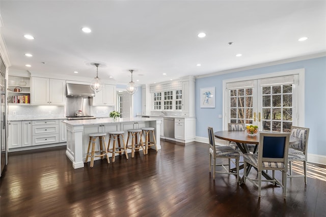 kitchen featuring under cabinet range hood, white cabinetry, appliances with stainless steel finishes, open shelves, and crown molding