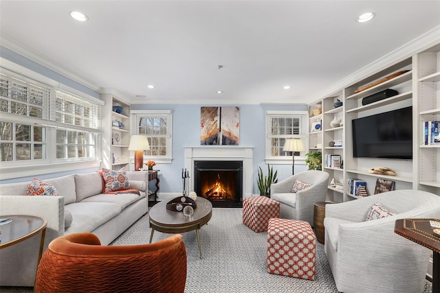 living area featuring ornamental molding, recessed lighting, a lit fireplace, and baseboards