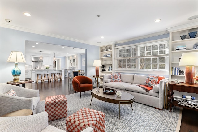 living area featuring recessed lighting, crown molding, and wood finished floors