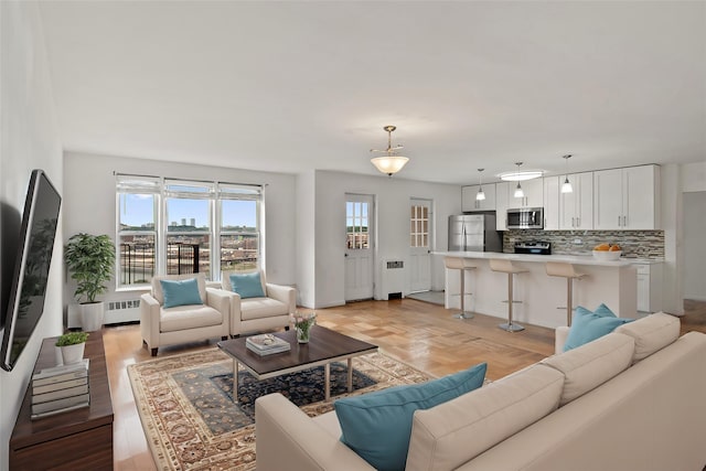 living room featuring parquet floors and radiator heating unit