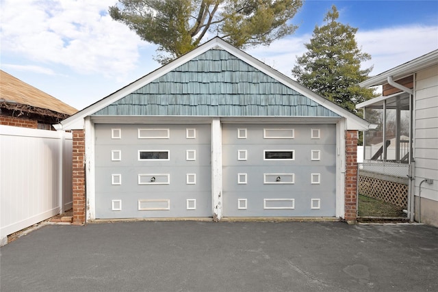 detached garage featuring fence