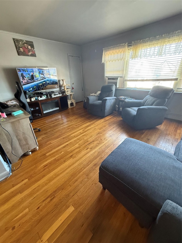 living area with hardwood / wood-style flooring and cooling unit