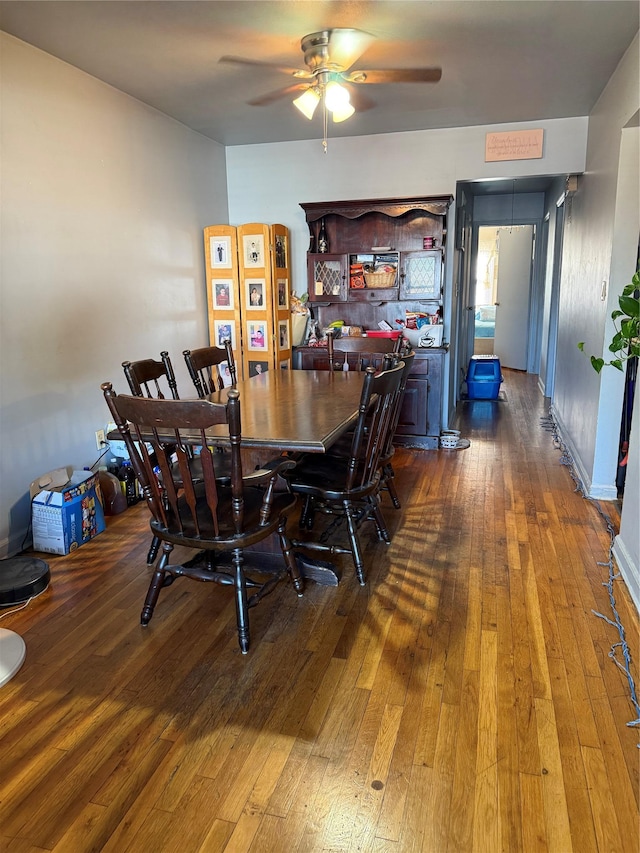 dining area with dark wood-style floors and a ceiling fan