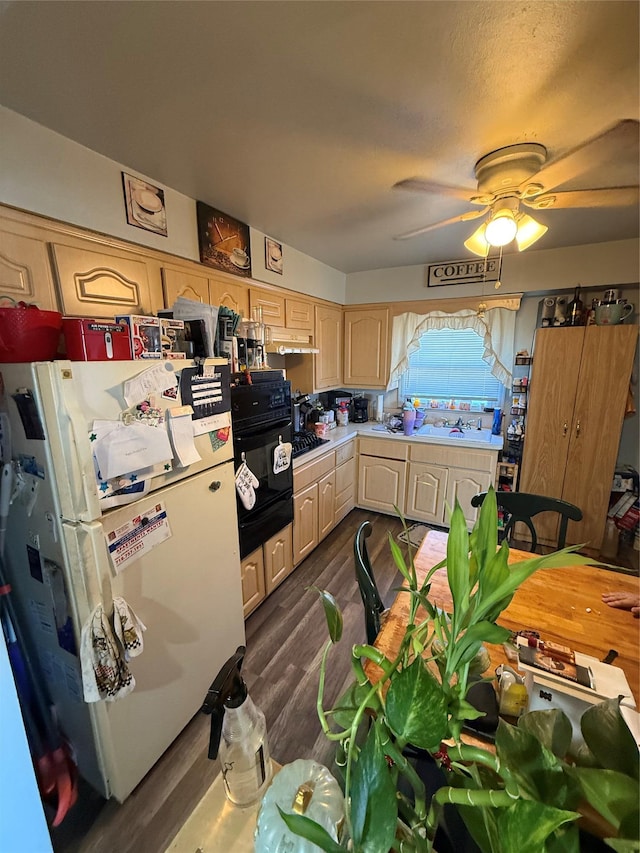 kitchen with light brown cabinets, a ceiling fan, light countertops, black appliances, and dark wood finished floors