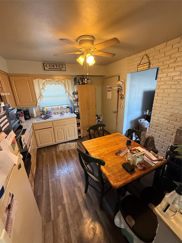 dining space featuring dark wood-style floors, ceiling fan, a textured ceiling, and brick wall