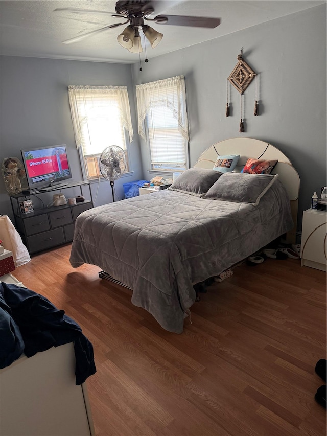 bedroom featuring a ceiling fan and wood finished floors