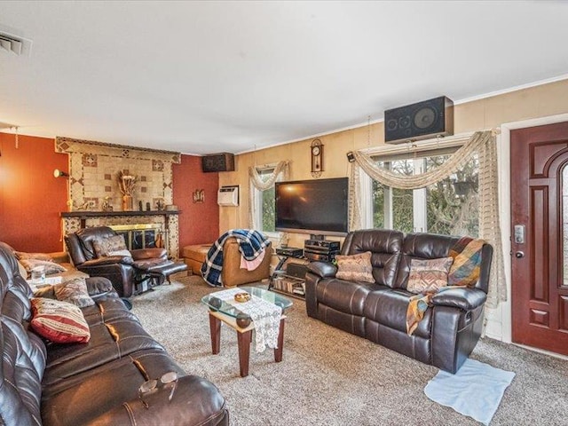 living area with carpet floors, a brick fireplace, visible vents, and a wall mounted AC