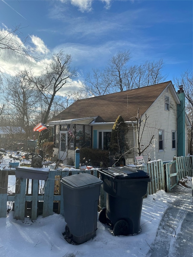 view of snow covered rear of property