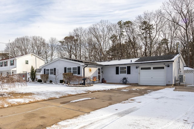 single story home with a garage and driveway