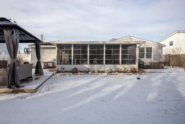 snow covered house with a sunroom