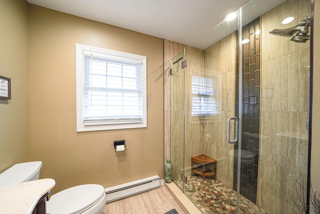 full bath featuring a baseboard radiator, toilet, wood finished floors, vanity, and a shower stall