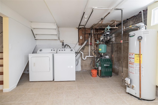 laundry room with water heater, laundry area, washer and clothes dryer, and a heating unit