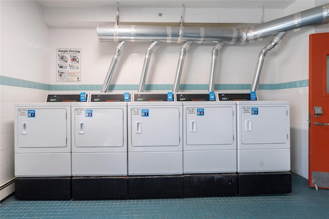 community laundry room with washing machine and clothes dryer