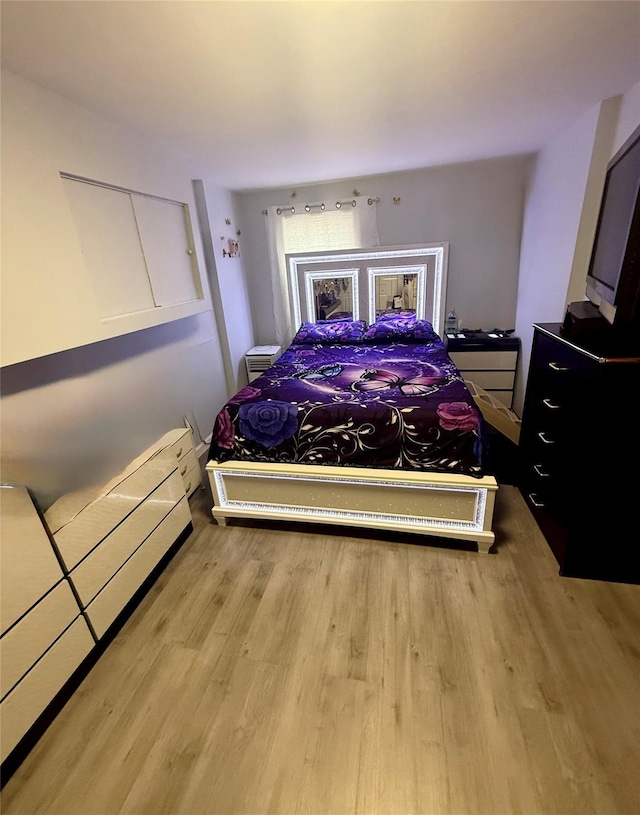 bedroom featuring wood finished floors