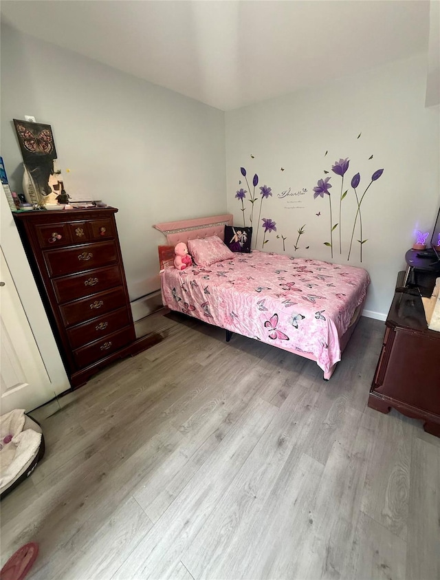 bedroom featuring wood finished floors