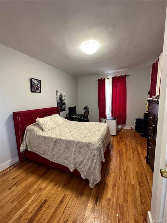 bedroom with light wood-style floors and baseboards