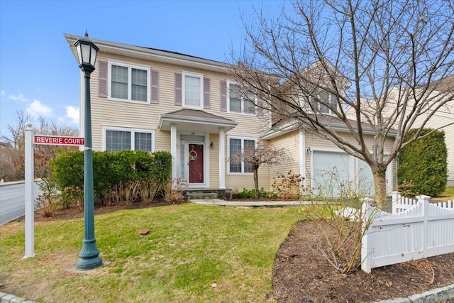 view of front of house featuring an attached garage, fence, and a front lawn