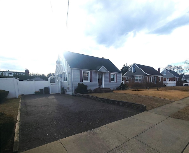 view of front facade with a residential view and fence