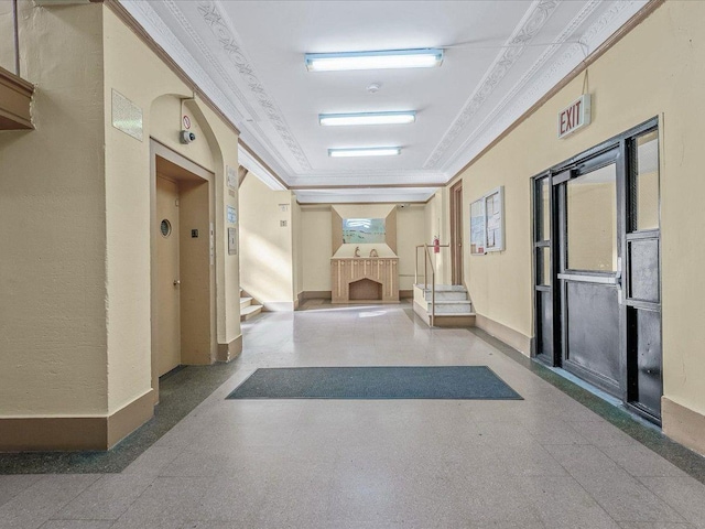 corridor with ornamental molding, stairway, and baseboards