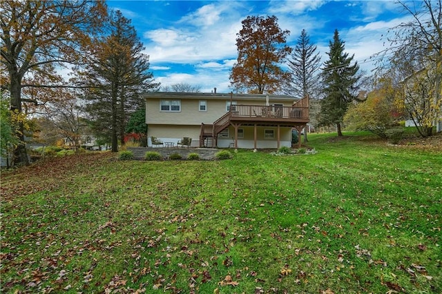 rear view of house with stairway, a lawn, and a wooden deck