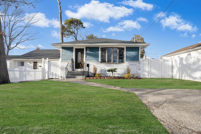 bungalow-style home featuring a front yard, fence private yard, and a gate