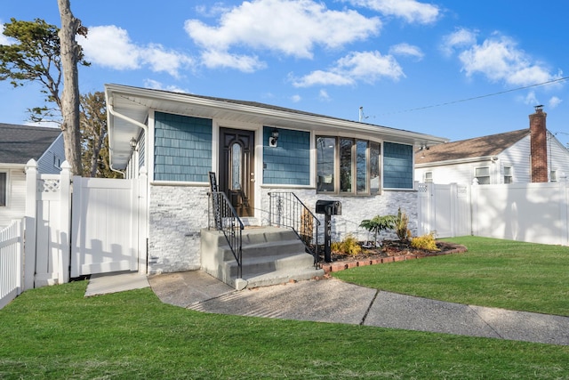 bungalow with stone siding, a gate, fence, and a front yard